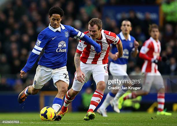 Steven Pienaar of Everton shields the ball from Glenn Whelan of Stoke City during the Barclays Premier League match between Everton and Stoke City at...