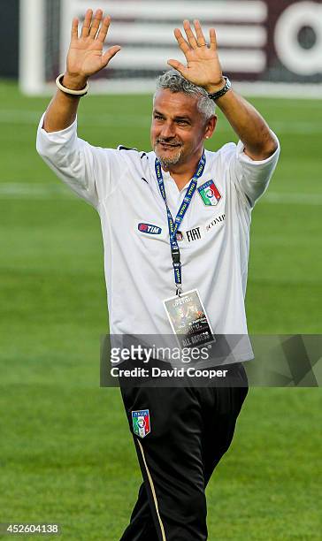 Italian soccer star Roberto Baggio waves to the crowd as the teams come onto the field for the Italy vs Portugal Legends game at BMO Field July 21,...