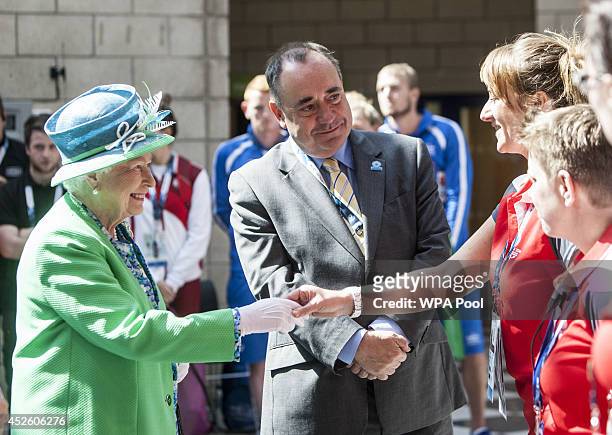 Queen Elizabeth II is introduced to Games volunteers by Alex Salmond, Scotland's First Minister, as she and The Duke of Edinburgh visit the Tollcross...