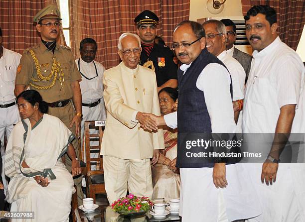 State BJP leaders Siddharth Nath Singh and Rahul Sinha greet new Governor of West Bengal Keshari Nath Tripathi during tea party after his swearing-in...
