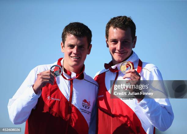Silver medalist Jonathan Brownlee of England and Gold medalist Alistair Brownlee of England celebrate on the podium during the medal ceremony for the...