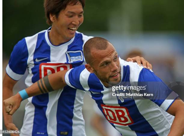 John Heitinga of Berlin jubilates with team mate Genki Haraguchi after scoring the first goal during the pre season friendly match between Hertha BSC...