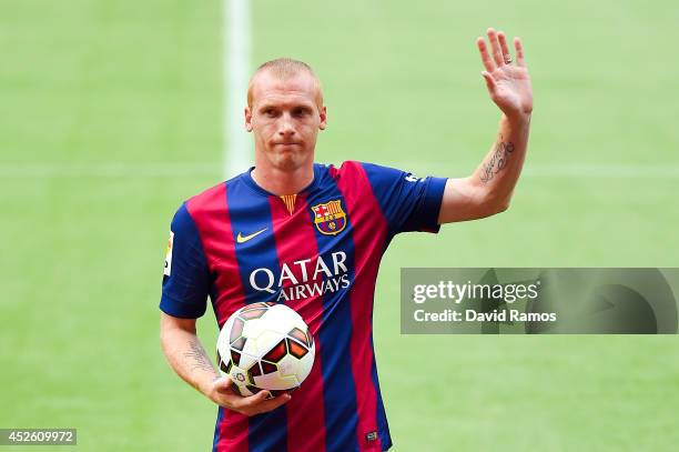Jeremy Mathieu poses as a new player of FC barcelona at the Camp Nou on July 24, 2014 in Barcelona, Spain.