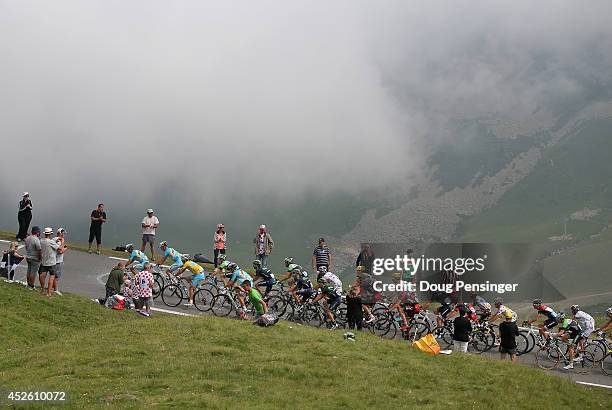 Vincenzo Nibali of Italy and the Astana Pro Team defends the overall race leader's yellow jersey as he and his teammates lead the group into the...