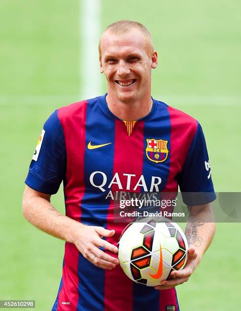 Jeremy Mathieu poses as a new player of FC barcelona at the Camp Nou on July 24, 2014 in Barcelona, Spain.