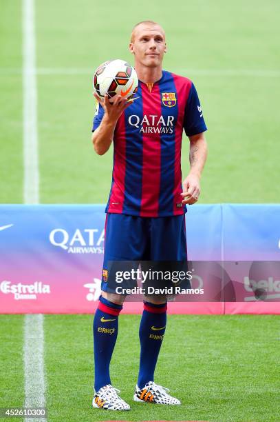 Jeremy Mathieu poses as a new player of FC barcelona at the Camp Nou on July 24, 2014 in Barcelona, Spain.