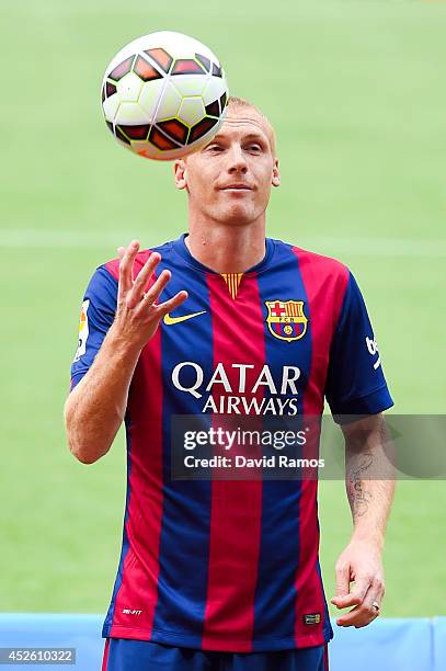 Jeremy Mathieu poses as a new player of FC barcelona at the Camp Nou on July 24, 2014 in Barcelona, Spain.