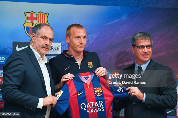 Jeremy Mathieu poses with the FC Barcelona sport director Andoni Zubizarreta and FC Barcelona Vice-President Jordi Mestre as a new player of FC...