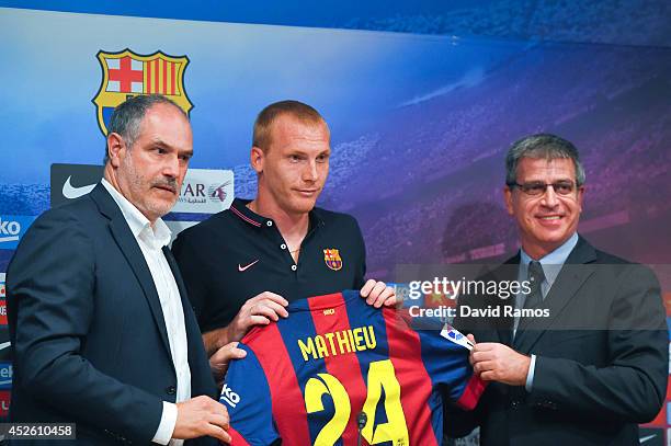 Jeremy Mathieu poses with the FC Barcelona sport director Andoni Zubizarreta and FC Barcelona Vice-President Jordi Mestre as a new player of FC...