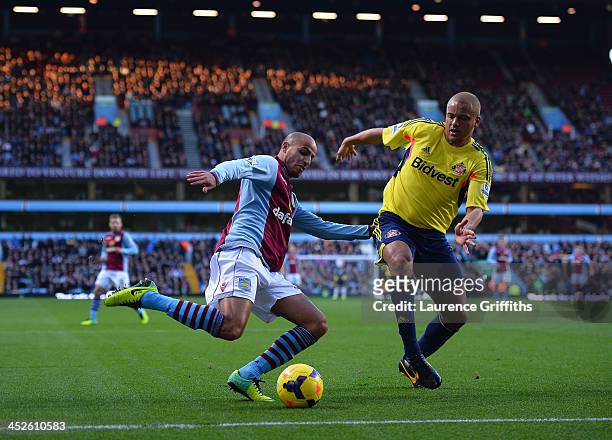 Karim El Ahmadi of Aston Villa battles with Wes Brown of Sunderland during the Barclays Premier League match between Aston Villa and Sunderland at...