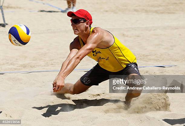 Chris Towe from Canada dives to get to the ball during the FIVB U21 World Beach Volleyball Championships on July 24, 2014 in Larnaca, Cyprus.