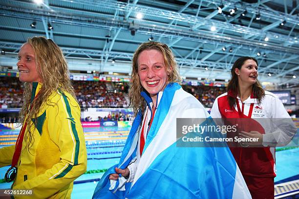 Gold medallist Hannah Miley of Scotland smiles with Silver medallist Aimee Willmott of England and Bronze medallist Keryn McMaster of Australia after...