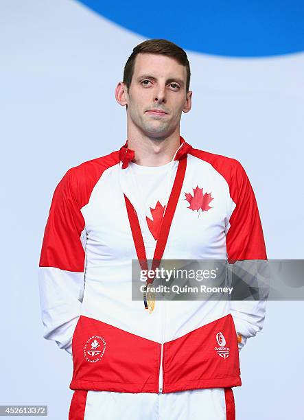 Ryan Cochrane of Canada poses with his gold medal during the medal ceremony for the Men's 400m Freestyle Final at Tollcross International Swimming...