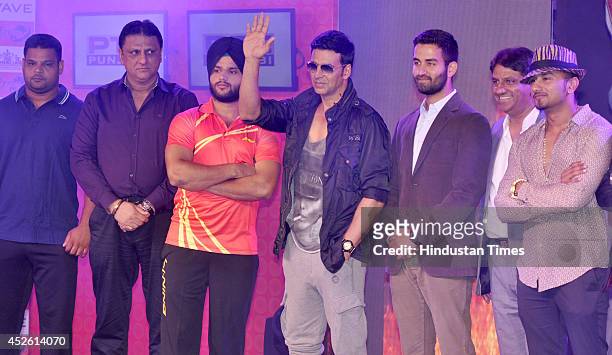 Team Speedy Singhs co-owner Akshay Kumar and team Yo Yo Tigers co-owner Yo Yo Honey Singh with kabaddi players during the unveiling of league...