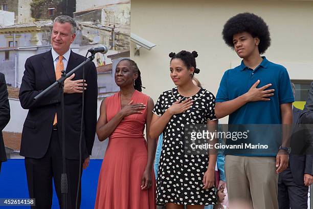 New York City Mayor Bill de Blasio, Chirlane McCray, Chiara de Blasio and Dante de Blasio stand for the national anthem at a welcome ceremony during...