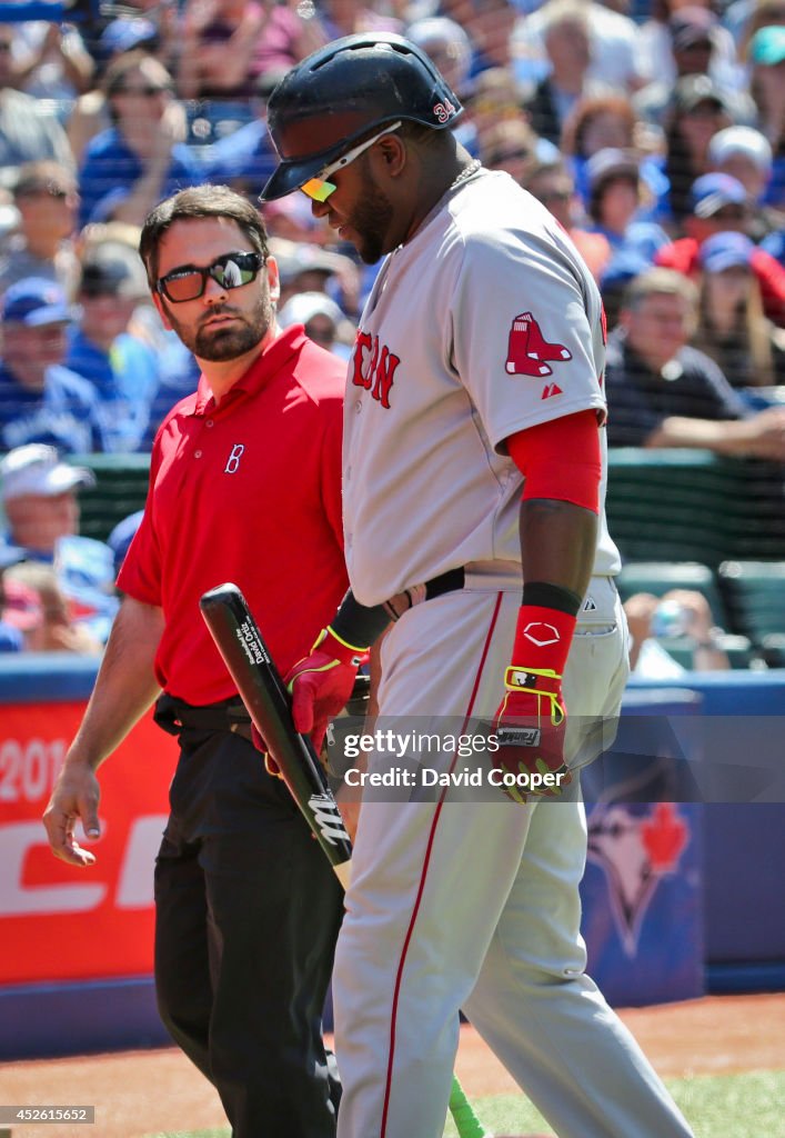 David Ortiz (34) of the Boston Red Sox injures himself at the plate in the top of the 9th and had to leave the game with help of Brad Pearson, Assistant Athletic Trainer