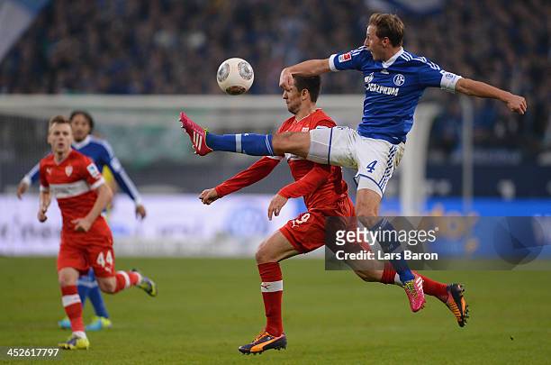 Vedad Ibisevic of Stuttgart is challenged by Benedikt Hoewedes of Schalke during the Bundesliga match between FC Schalke 04 and VfB Stuttgart at...