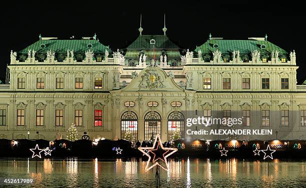 Christmas lights are seen in front of the Belvedere Palace in Vienna on November 30, 2013. AFP PHOTO / ALEXANDER KLEIN