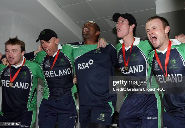 Paul Stirling, Trent Johnston, coach Phil Simmonds, George Dockrell and William Porterfield sing their song in the dressing rooms after Irelands...