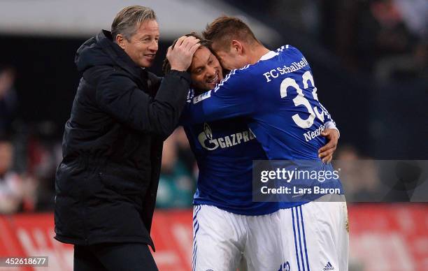 Jermaine Jones of Schalke celebrates with head coach Jens Keller and team mate Roman Neustaedter after scoring his teams third goal during the...