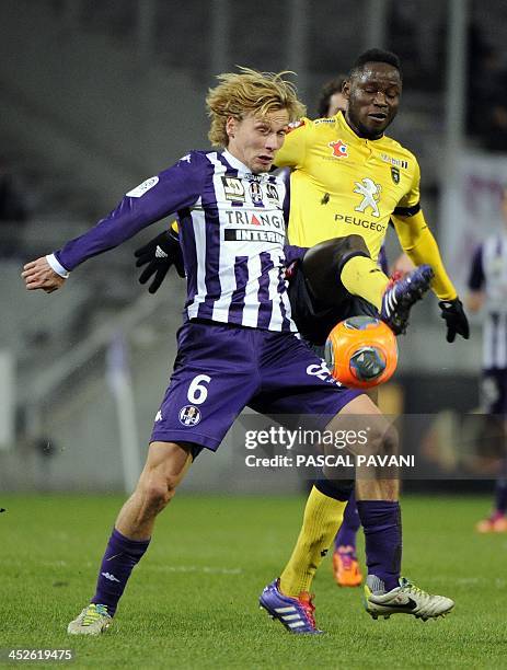 Toulouse's French midfielder Clement Chantone vies with Sochaux's midfelder Joseph Lopy during a French L1 football match between Toulouse and...
