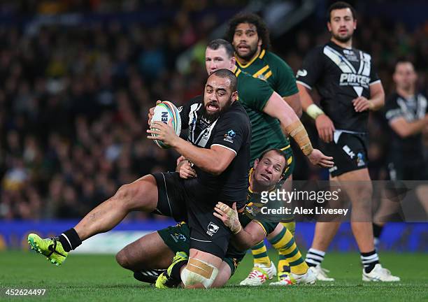 Sam Kasiano of New Zealand is tackled by Matthew Scott of Australia during the Rugby League World Cup Final between New Zealand and Australia at Old...