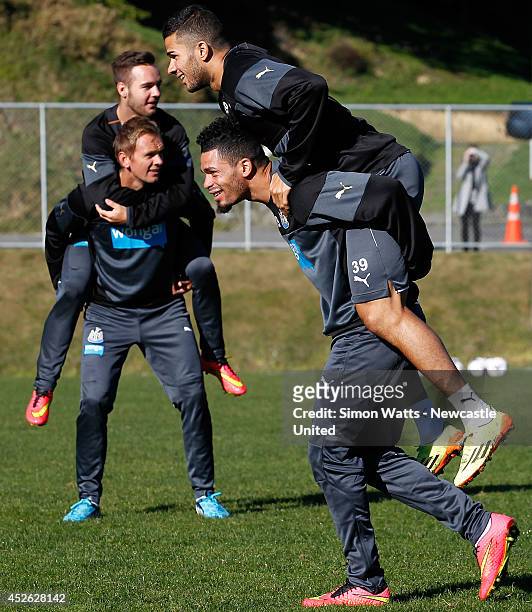 Emmanuel Riviere carries Mehdi Abeid during a Newcastle United training session at Newtown on July 25, 2014 in Wellington, New Zealand.