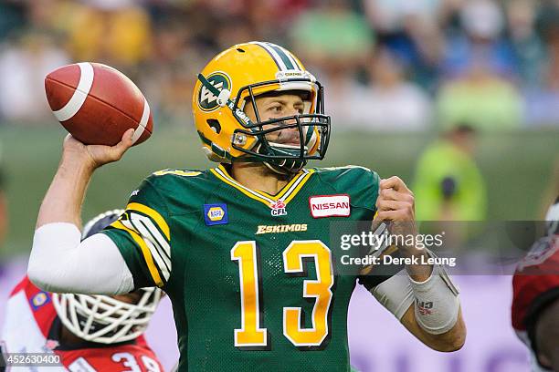 Mike Reilly of the Edmonton Eskimos makes a pass against the Calgary Stampeders during a CFL game at Commonwealth Stadium on July 24, 2014 in...