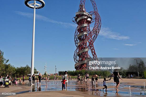 As the temperature soars over 25 degrees, during the hottest day of the year, people get fresh in the Olympic Village in Stratford. On the background...