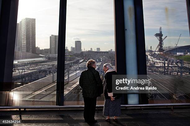 Two women are looking at new buildings in Stratford, East London.