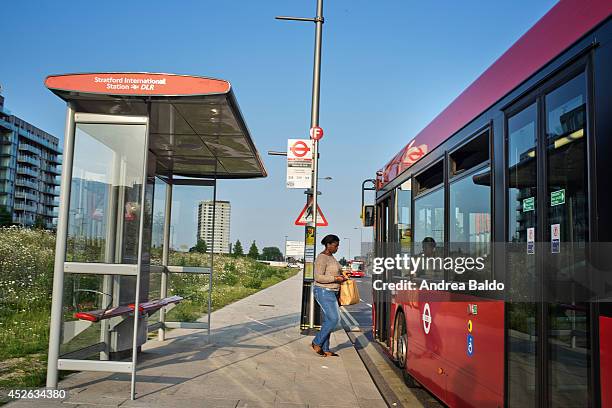 Woman is getting a bus in the East Village in Stratford, East London.