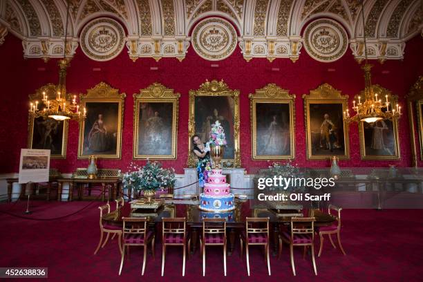 Anna Reynolds, curator of Royal Collection Trust, puts the finishing touches to a display of the 1853 christening cake of Prince Leopold in the State...