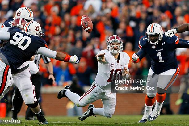 McCarron of the Alabama Crimson Tide attempts a shuttle pass under pressure in the second quarter against the Auburn Tigers at Jordan-Hare Stadium on...