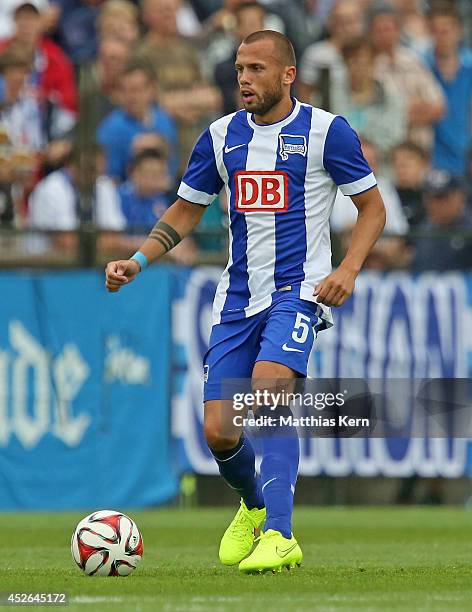 John Heitinga of Berlin runs with the ball during the pre season friendly match between Hertha BSC and PSV Eindhoven at Stadion am Wurfplatz on July...