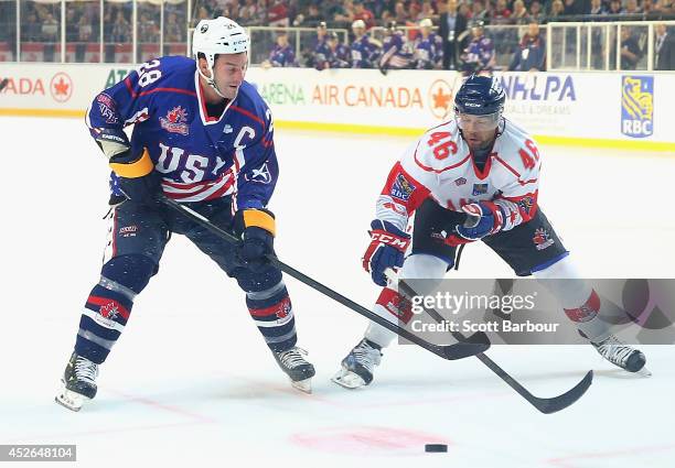 Zenon Konopka of the USA and Jordan Owens of Canada compete for the puck during the International Ice Hockey Series match between the United States...