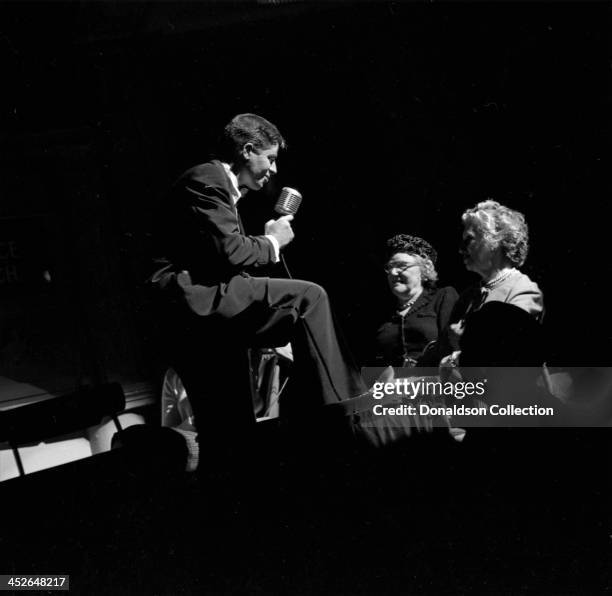 Comedian and entertainer Jerry Lewis performs onstage at the RKO Palace Theater on Broadway on February 7, 1957 in New York, New York.