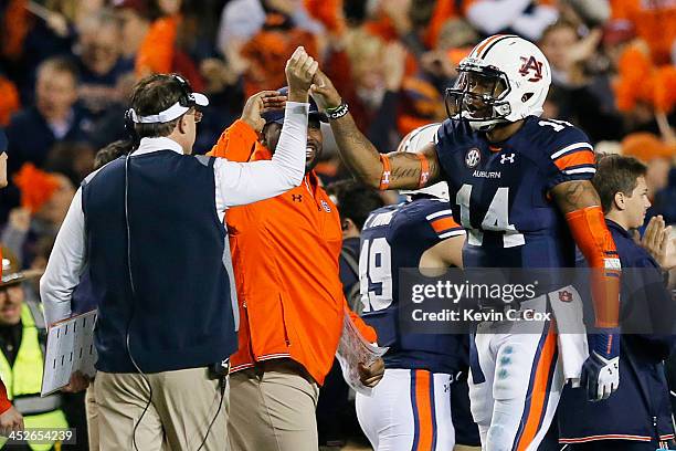 Nick Marshall celebrates with head coach Gus Malzahn of the Auburn Tigers in the fourth quarter against the Alabama Crimson Tide at Jordan-Hare...