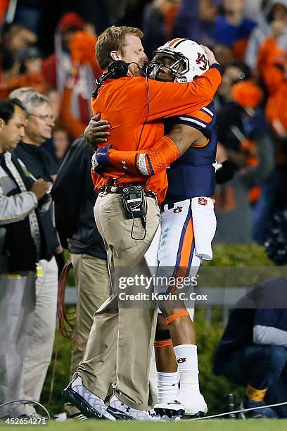 Nick Marshall celebrates with offensive coordinator Rhett Lashlee of the Auburn Tigers in the fourth quarter against the Alabama Crimson Tide at...