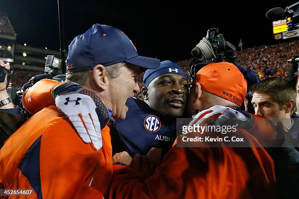 Chris Davis of the Auburn Tigers celebrates with coaching staff after scoring the winning touchdown to defeat the Alabama Crimson Tide 34 to 28 at...
