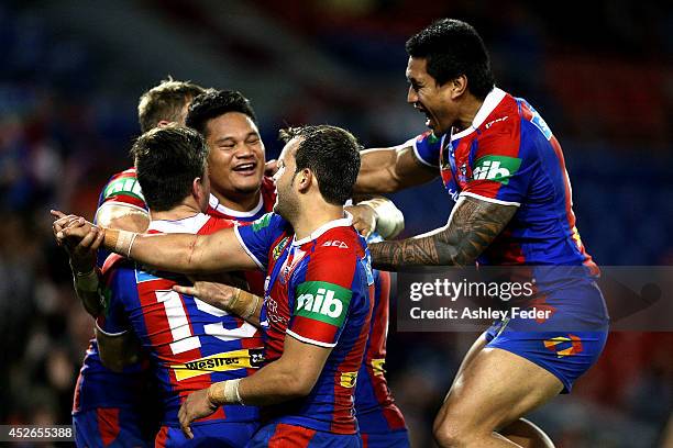 Knights teammaates celebrate a try by Joey Leilua during the round 20 NRL match between the Newcastle Knights and the Sydney Roosters at Hunter...