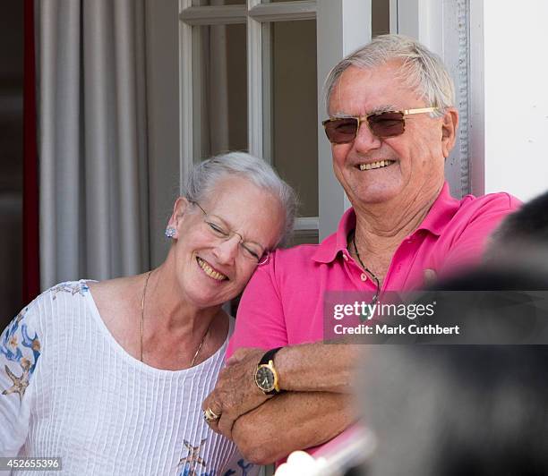 Queen Margrethe II of Denmark and Prince Henrik of Denmark watch the changing of the guard at Grasten Castle on July 25, 2014 in Grasten, Denmark.