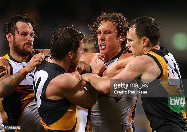Matt Priddis of the Eagles wrestles with Reece Conca and Nathan Foley of the Tigers during the round 18 AFL match between the West Coast Eagles and...