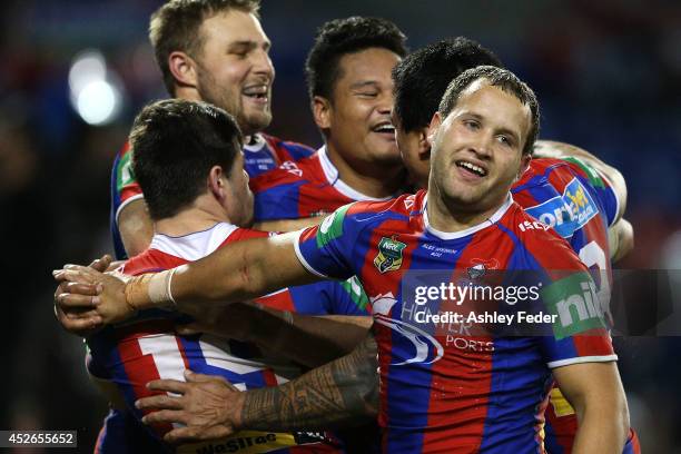 Knights teammaates celebrate a try by Joey Leilua during the round 20 NRL match between the Newcastle Knights and the Sydney Roosters at Hunter...