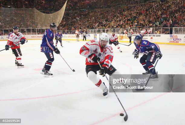 Matt Kassian of Canada competes for the puck during the International Ice Hockey Series match between the United States and Canada at Rod Laver Arena...