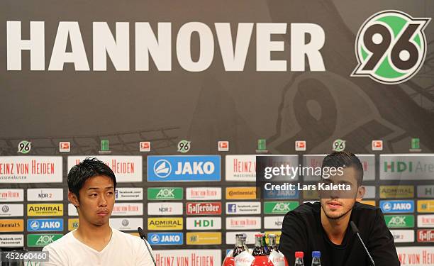 New signings Hiroshi Kiyotake and Ceyhun Guelselam are seen during a press conference at HDI Arena on July 25, 2014 in Hanover, Germany.