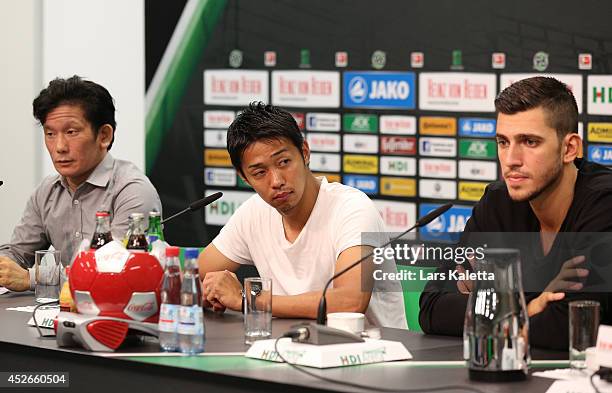 New signings Hiroshi Kiyotake and Ceyhun Guelselam are seen during a press conference at HDI Arena on July 25, 2014 in Hanover, Germany.