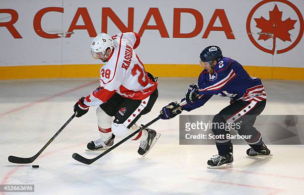 Matt Kassian of Canada and Kevin Ryan of the USA compete for the puck during the International Ice Hockey Series match between the United States and...