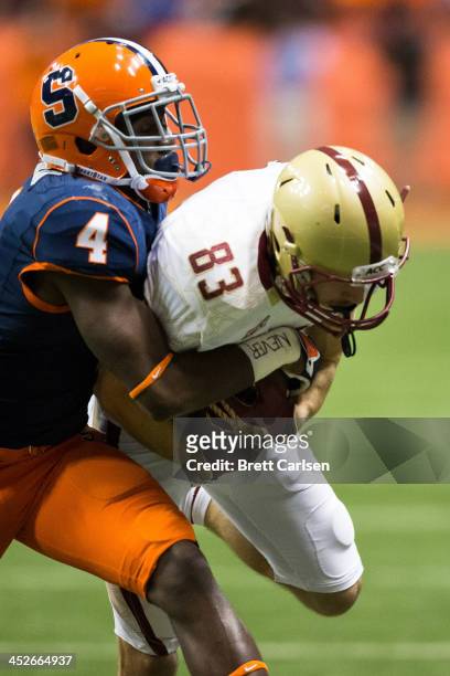 Brandon Reddish of the Syracuse Orange brings down Alex Amidon of the Boston College Eagles following a reception in the second quarter which setup a...