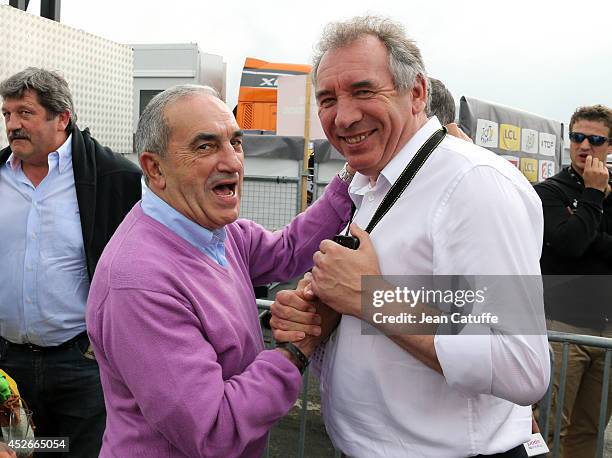 President of the French Tennis Federation Jean Gachassin and Mayor of Pau Francois Bayrou pose near the finish line after stage eighteen of the 2014...