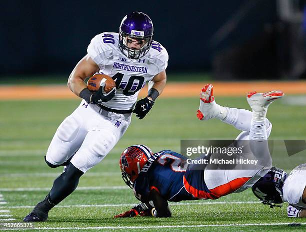Fullback Dan Vitale of the Northwestern Wildcats runs the ball as defensive back V'Angelo Bentley of the Illinois Fighting Illini stumbles at...